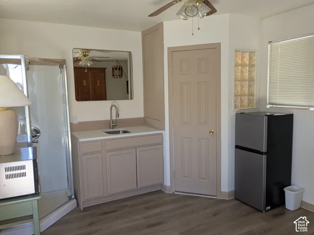 Wood-finish flooring with a neutral-toned vanity and integrated sink
