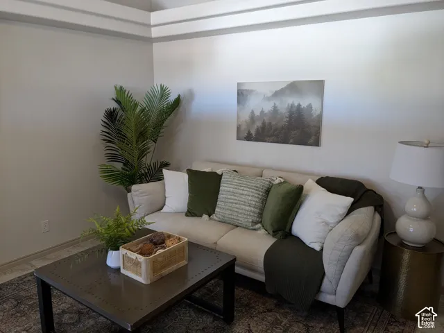 Tray ceiling detail, neutral wall tones, and tiled flooring