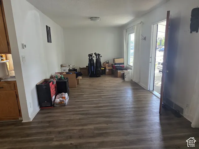 Wood-finish flooring throughout, white painted walls, and a visible built-in ceiling light fixture