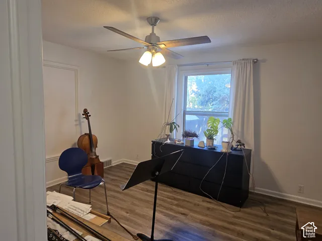 Recessed window with white trim, wood-finish flooring, ceiling fan with integrated lighting, and white baseboards