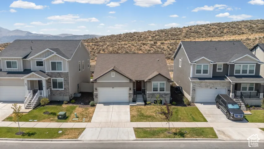 Single-story residence with a two-car garage, concrete driveway, and stone accents