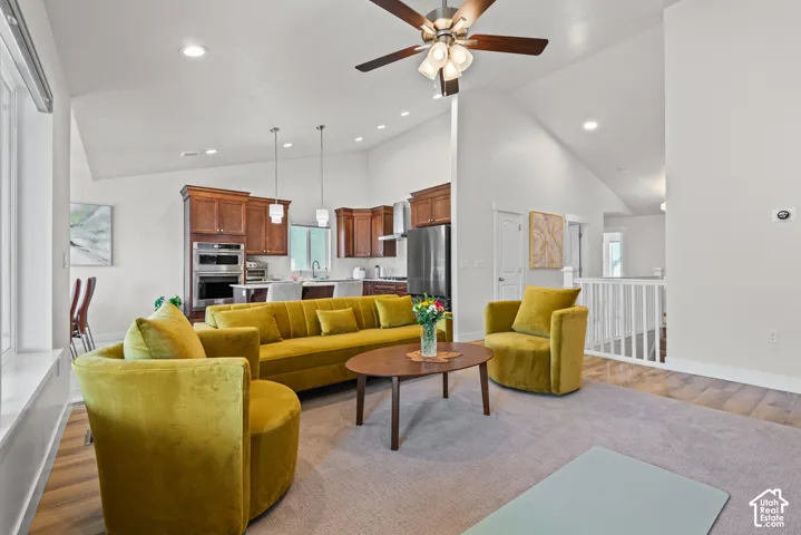 Vaulted ceilings, recessed lighting, and a wood-finish ceiling fan