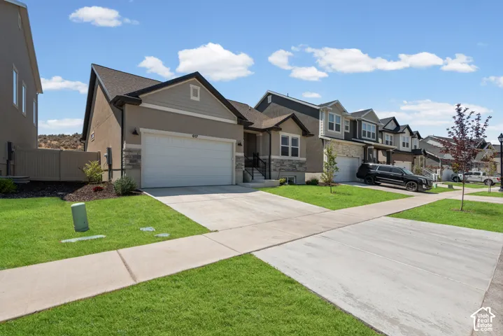 Modern craftsman-style exterior with a two-car garage, concrete driveway, and established front landscaping