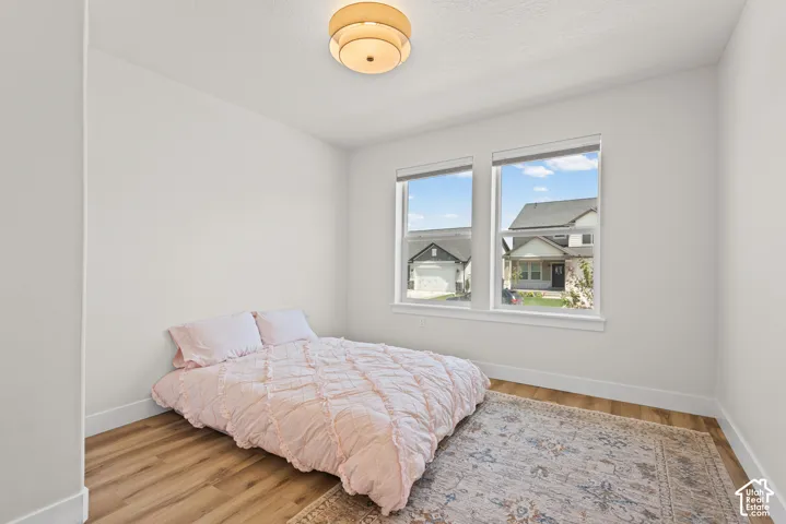 Recessed lighting, wood-finish flooring, white walls, and dual windows