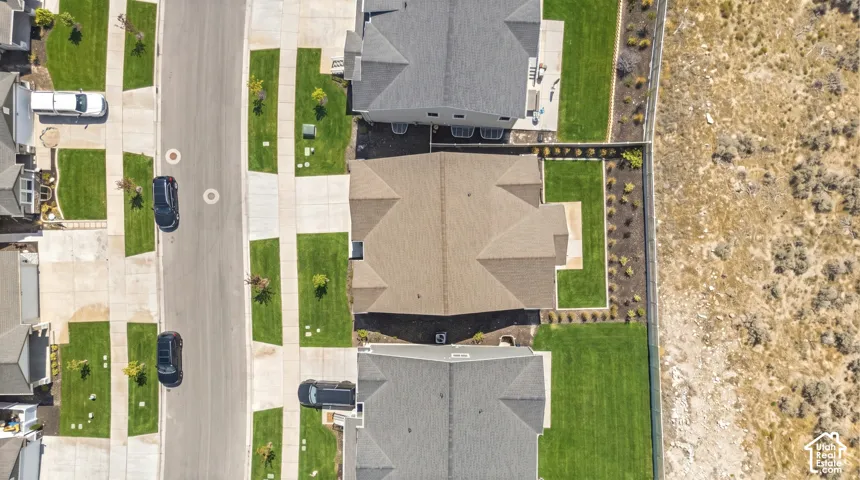 Residential property with a gabled roof and surrounding manicured lawn