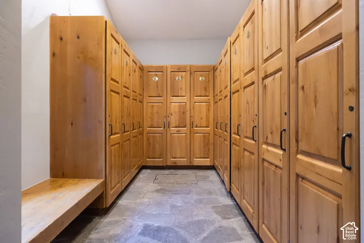 U-shaped built-in wooden lockers with paneled doors and black hardware