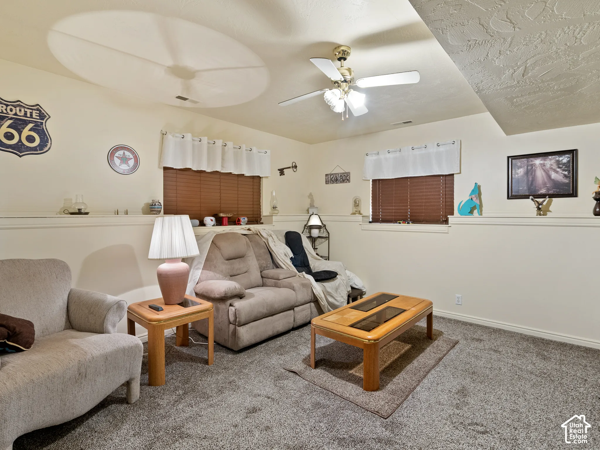 Recessed windows with blinds, carpet flooring, a ceiling fan, and built-in shelving