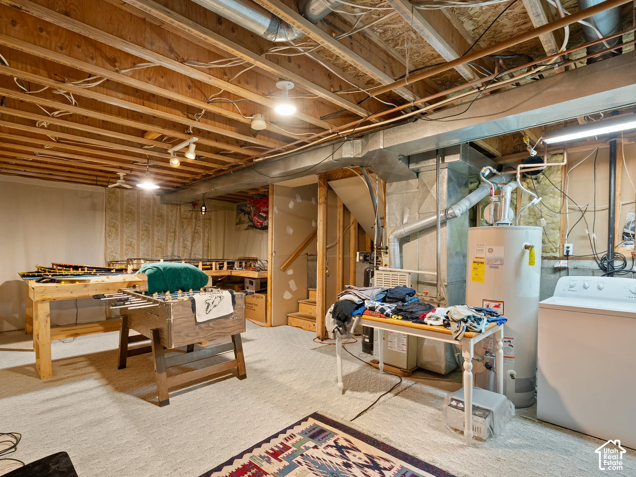 Carpeted flooring, exposed ceiling joists, and recessed lighting
