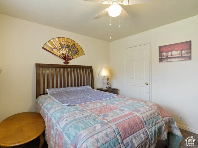 Textured carpeting and a permanent ceiling fan with an integrated light fixture