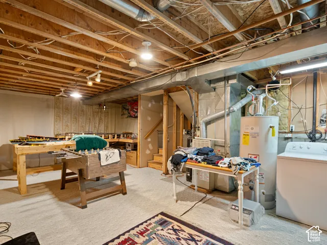 Carpeted flooring, exposed ceiling joists, and recessed lighting