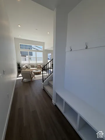 Wood-finish flooring throughout, complemented by a built-in bench with storage cubbies and wall-mounted hooks. *Furniture not included