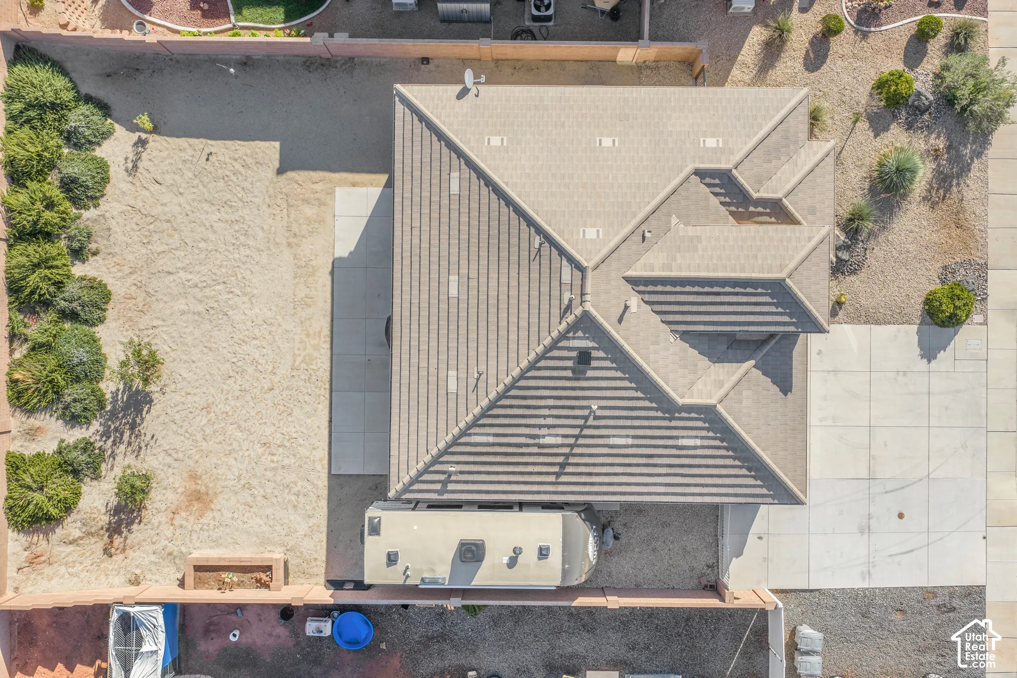 Aerial view showcasing a modern residence with a striking pitched roof featuring corrugated metal panels and clean geometric lines