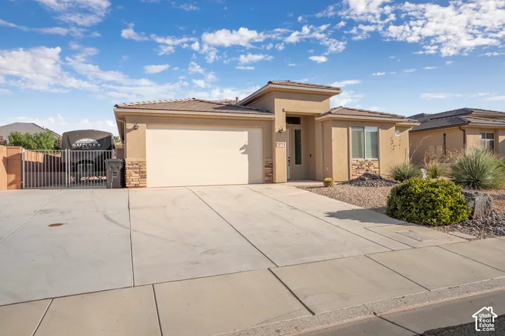 Stucco exterior with stone accents and an attached two-car garage
