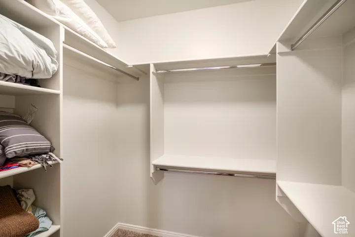 Custom built-in shelving, multiple hanging rods, and an integrated shelf system