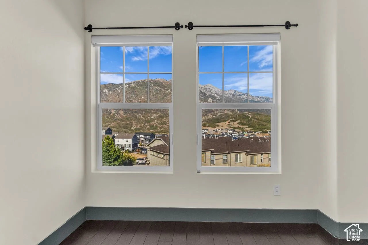 Secondary bedroom with hardwood floors and vaulted ceilings + those mountain views!