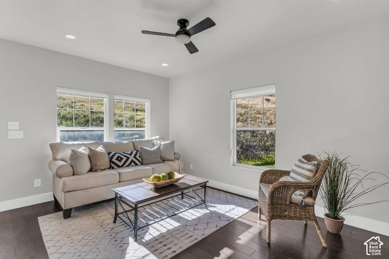 Lovely great room with recessed lights, modern fan, and hardwood floors