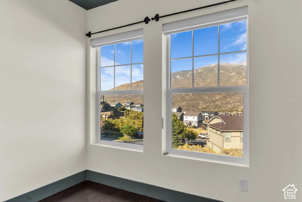 Secondary bedroom with hardwood floors and vaulted ceilings + those mountain views!