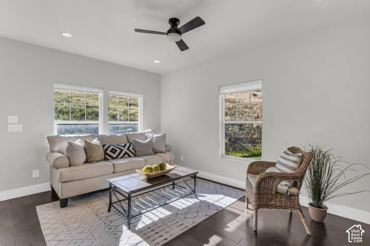 Lovely great room with recessed lights, modern fan, and hardwood floors