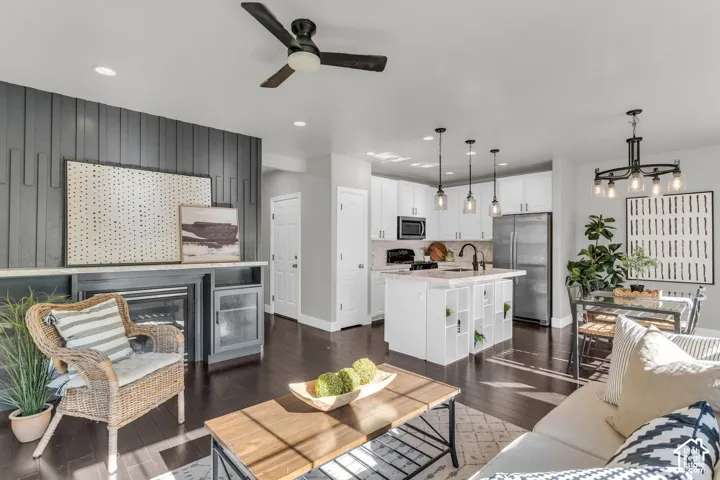 Updated great room. White cabinetry with beautiful marble countertops and backsplash. Hardwood flooring. Accent wall with built-ins around the cozy fireplace.