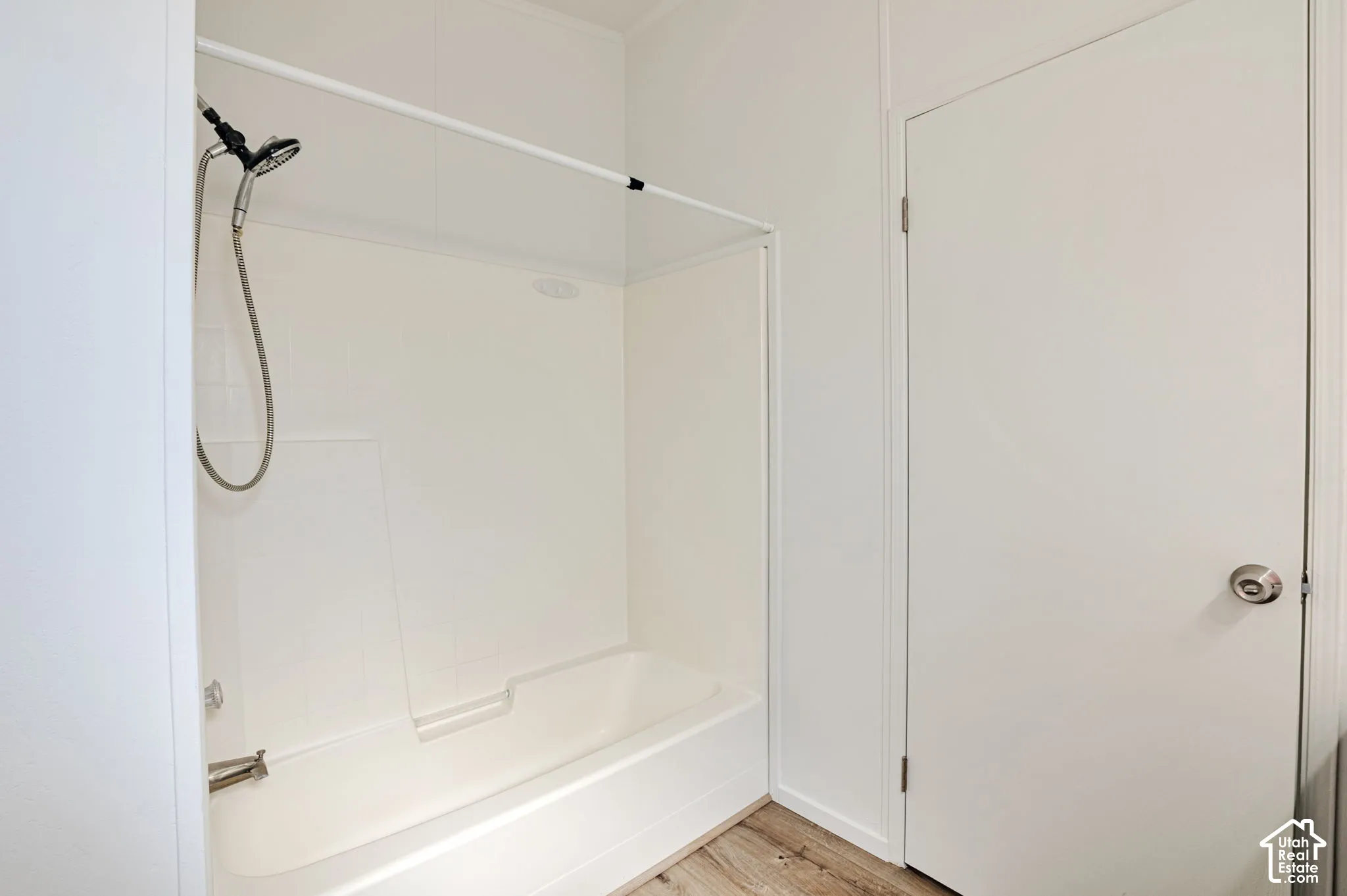 Modern bathroom featuring a frameless glass-enclosed shower with chrome fixtures, white subway tile surround, and a built-in bench seat