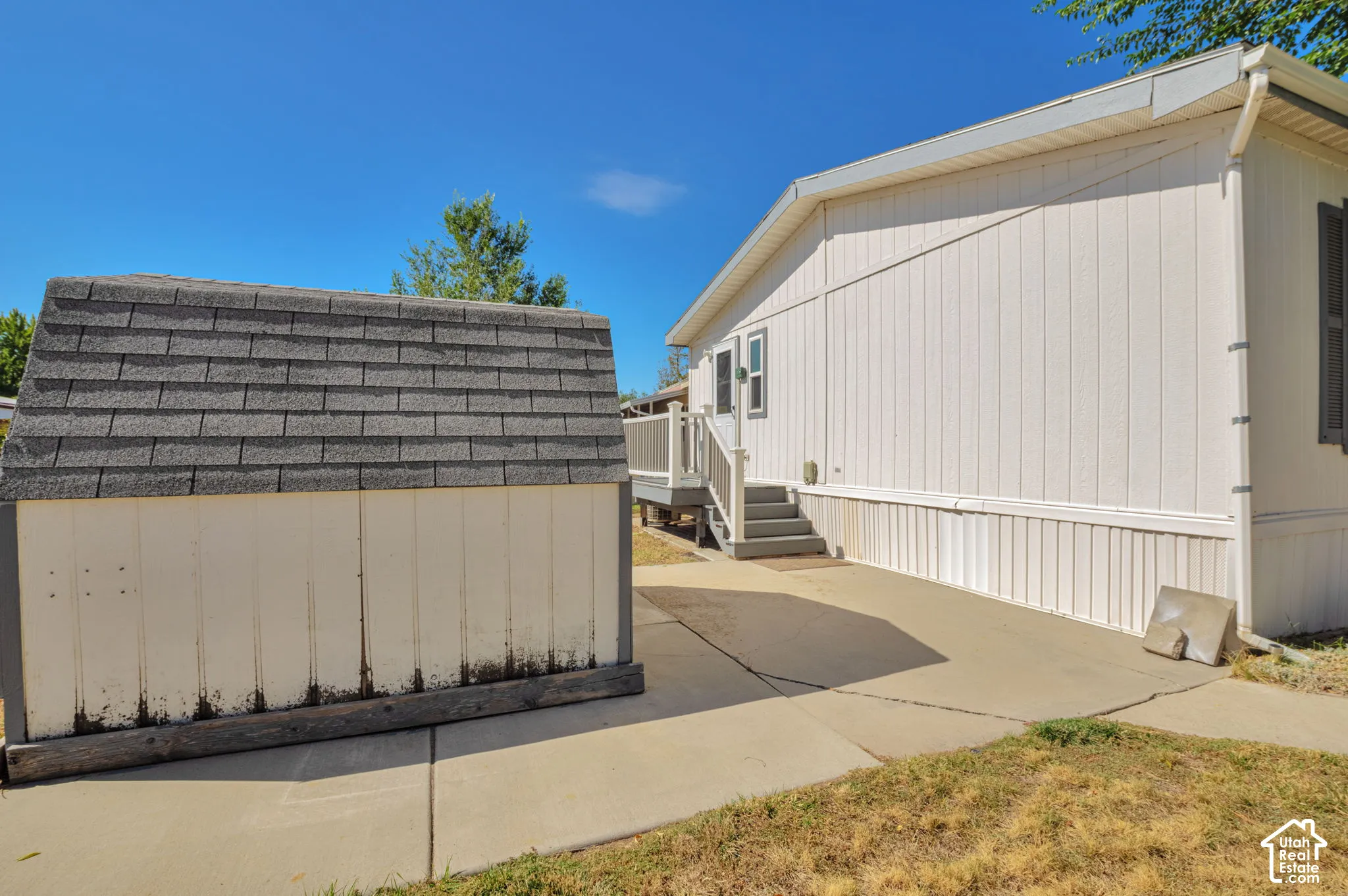 White vertical panel siding with gray shutters