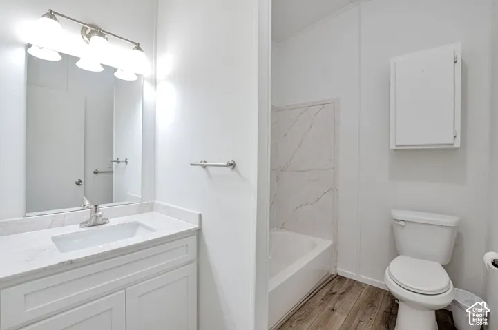 Vanity with undermount sink, countertop, framed mirror, and three-light fixture