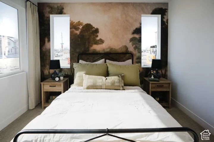 Feature wall with detailed mural artwork, integrated window framing, carpeted flooring, and a flat white ceiling