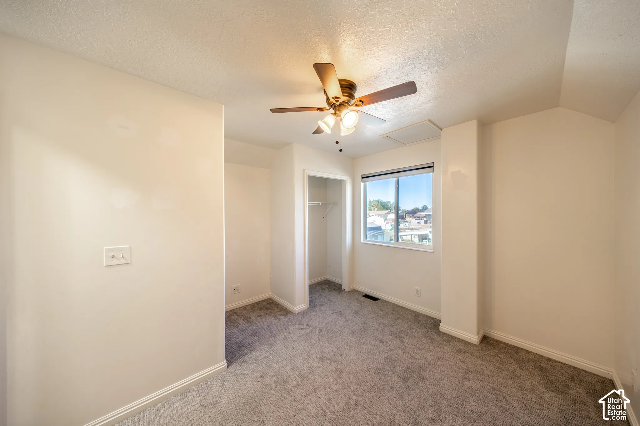 3rd bedroom located on 2nd floor. Recessed window, ceiling fan with integrated lighting, built-in closet with shelving, and gray carpet flooring