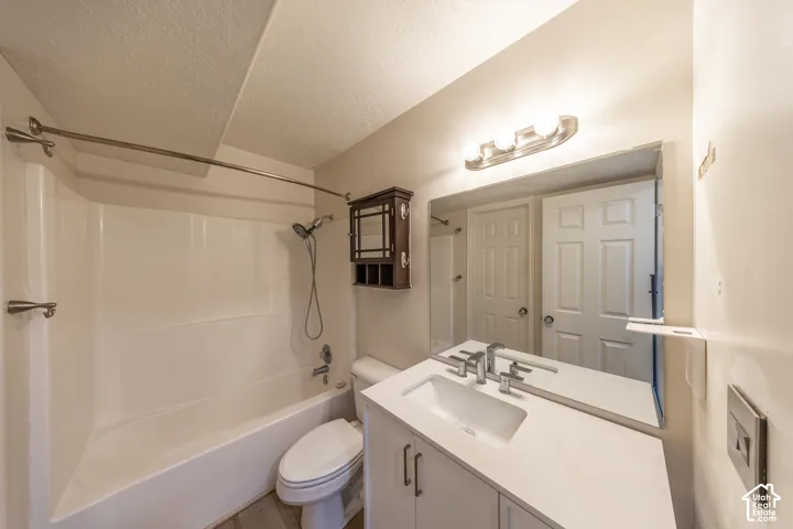 White vanity with rectangular sink, brushed nickel faucet, and integrated mirror