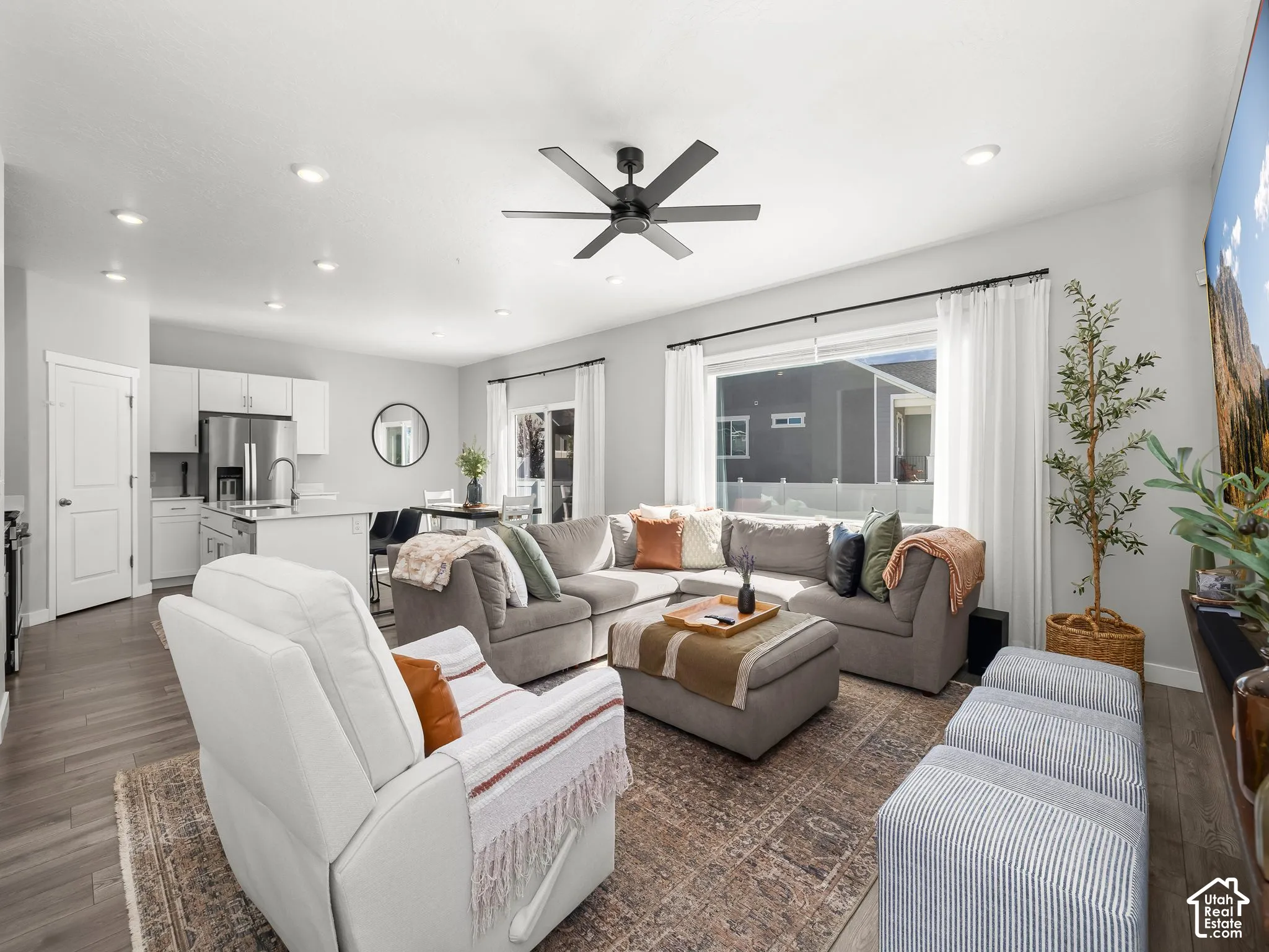 Wood-finish flooring, recessed lighting, and a contemporary ceiling fan
