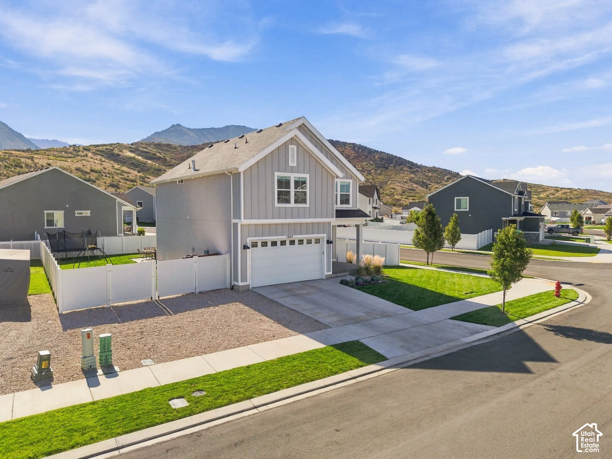 Modern two-story residence with a two-car garage, fenced backyard, and established landscaping