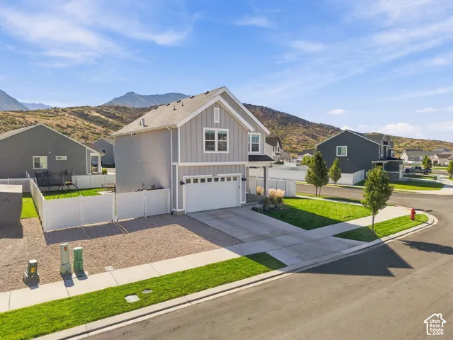 Modern two-story residence with a two-car garage, fenced backyard, and established landscaping