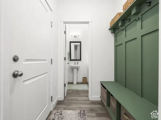 Mudroom featuring a built-in bench, upper shelf, and wall hooks