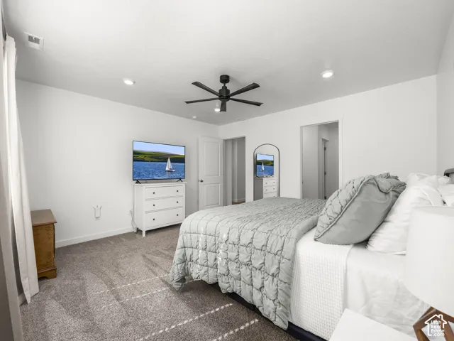 Recessed ceiling lighting, ceiling fan, neutral wall color, and gray carpeting