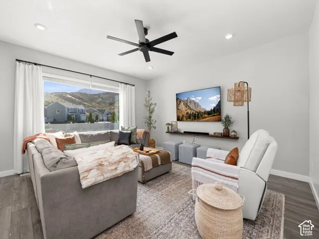 Recessed lighting, large picture window, ceiling fan, wood-finish flooring, and wall-mounted shelving