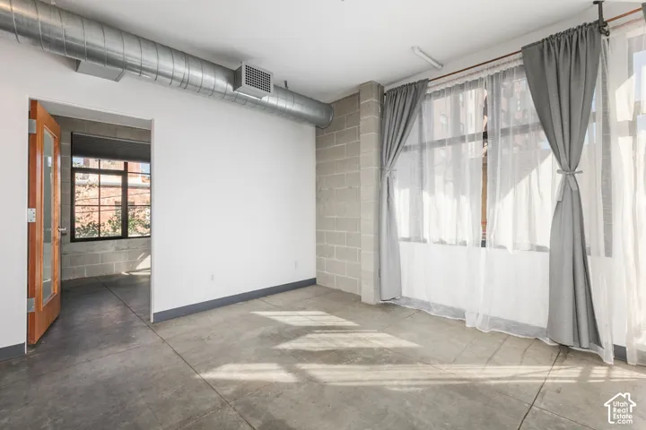 Polished concrete flooring, exposed spiral ductwork, and concrete block walls