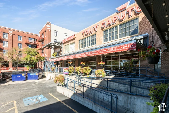Brick building with prominent retail frontage featuring an awning and large windows