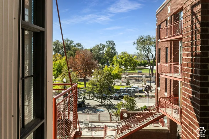 Brick exterior featuring multiple private balconies, exterior staircase, and clear story windows