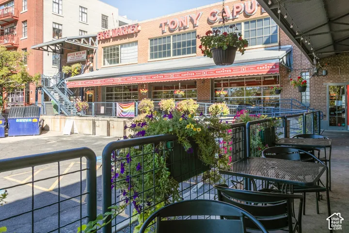Commercial brick building with multiple large windows and an industrial-style metal awning