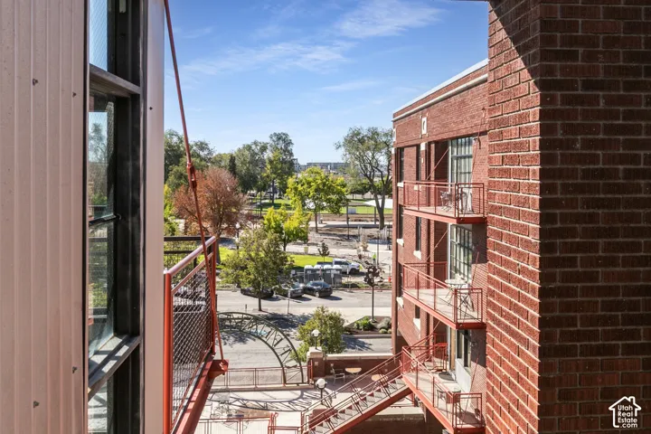 Red brick exterior with multiple balconies and a multi-level staircase