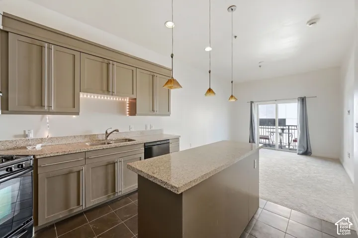 Kitchen with granite countertops, stainless steel sink, and gray cabinetry