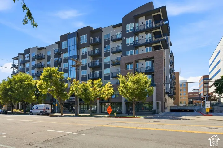 Modern multi-story building featuring a brick and panel facade