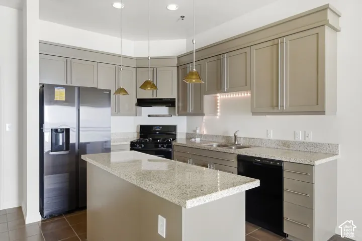 Kitchen featuring granite-style countertops, stainless steel refrigerator, black range, black dishwasher, and gray cabinetry