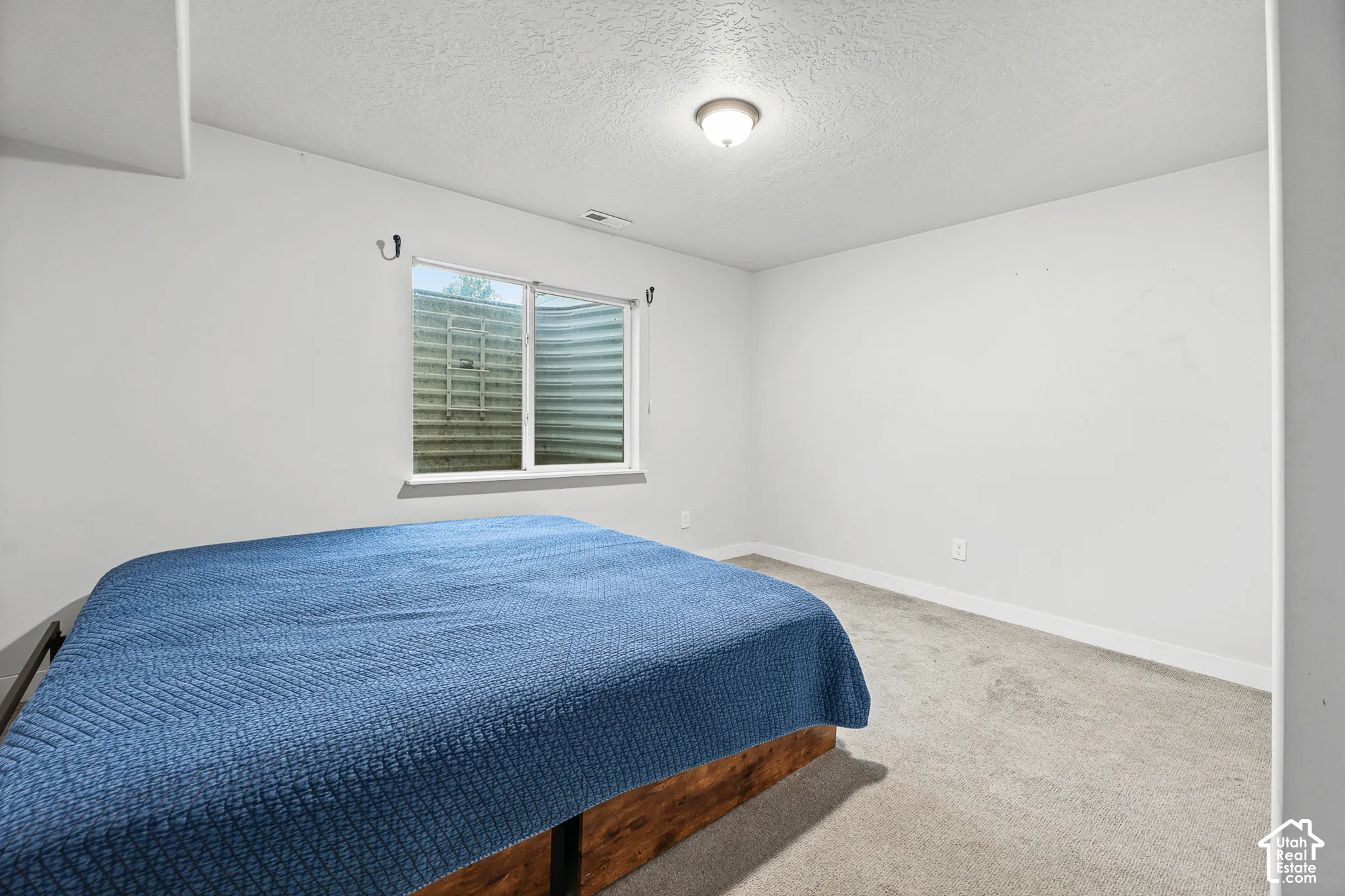Recessed window with a white frame and a window well