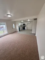 Carpeted living area with a large window