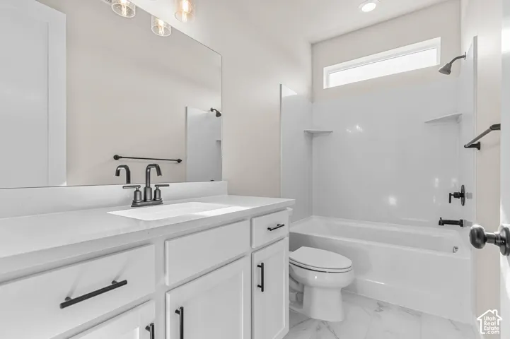 Vanity with white countertop, undermount sink, and dark bronze-finish fixtures