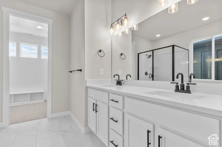Dual vanity with white cabinetry, matte black hardware, and integrated sinks