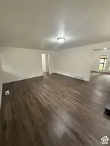 Wood-finish flooring throughout, neutral wall tones, and recessed ceiling lighting