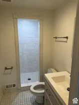 Walk-in shower with tiled walls and floor