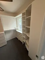 Built-in shelving, integrated drawers, and a window for natural illumination